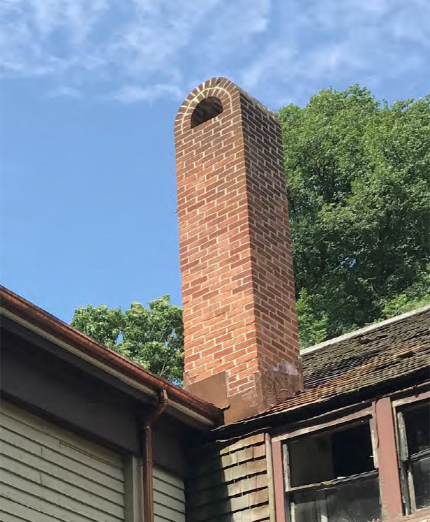 Completed chimney restoration included repointing and copper flashing.