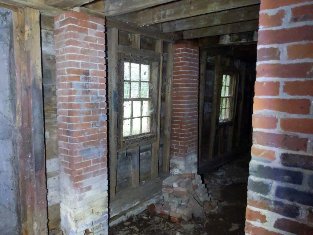 South wall was poorly supported by brick piers with deteriorated mortar that were not aligned with structural load paths and inadequate footings.